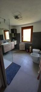 a bathroom with a toilet and a sink at Casa Christine in Villa Minozzo