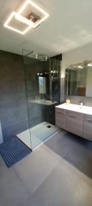 a bathroom with a glass shower and a sink at Casa Christine in Villa Minozzo