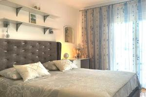 a bedroom with a large bed and a window at At Jenny in Omiš
