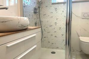 a bathroom with a sink and a shower at At Jenny in Omiš +11 photos