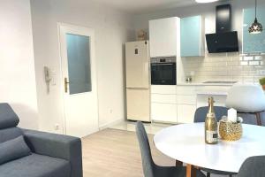 a living room with a table and a bottle of champagne at At Jenny in Omiš