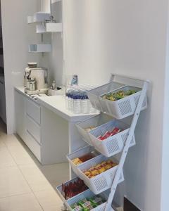 a kitchen with four baskets of fruits and vegetables at 金門且停民宿 可包棟 好停車 近市區 in Jinning