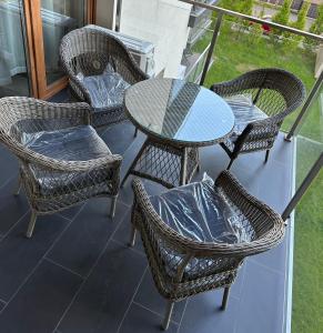 a group of chairs and a table on a balcony at GOLD Apartment Centrum garaż in Gliwice