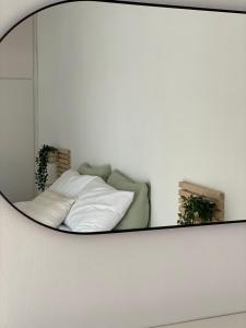 a mirror in a room with a bed and a couch at The Olive Ocean in Tolo