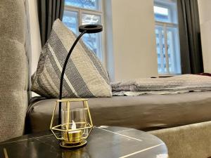 a lamp on a table in a living room with a couch at little cozy residence - enjoy Viennas summer season in Vienna