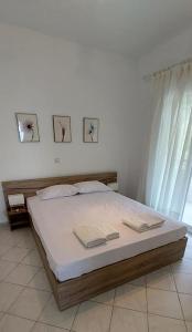 a bedroom with a bed with two towels on it at Ianos in Nea Skioni