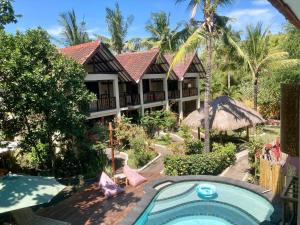 a resort with a swimming pool and a building at Lutwala Bungalows and Private Villa in Gili Trawangan