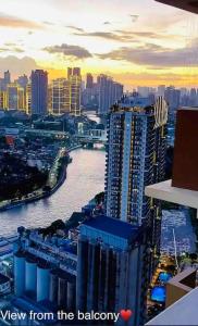a view of a city with a river and buildings at Fully-Airconditioned 2-BR Unit near BGC in Manila
