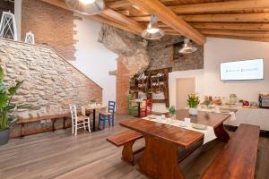 a room with a table and a stone wall at Porto di Clanezzo in Clanezzo