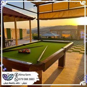 a pool table sitting on top of a patio at Alma Private Villa in Jerash