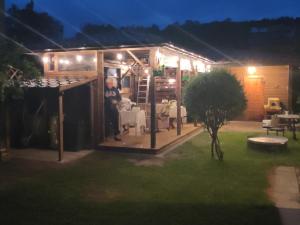 a man standing outside of a shed at night at Dom Sula in Ustrzyki Dolne