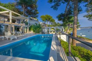 a swimming pool in the backyard of a house at Villa Hana Croatia in Mali Lošinj