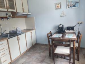 a kitchen with a table and chairs and a sink at White House Krapets in Krapets