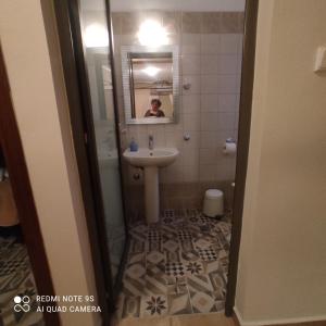 a bathroom with a sink and a mirror at Kastalia in Ammouliani