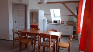 a kitchen and dining room with a table and chairs at Holiday Home Benecko 101 in Benecko