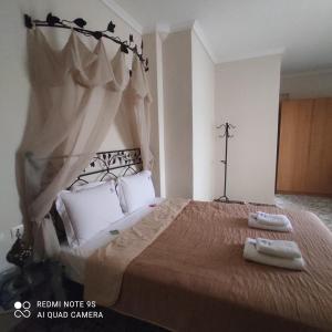 a bedroom with a large bed with two towels on it at Kastalia in Ammouliani