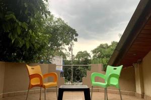 3 sillas y una mesa con un jarrón en el patio en Dili's Home Stay, en Kandy