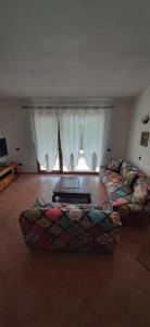 a large living room with a couch and a table at Artistika Golden Apartment in Capitana
