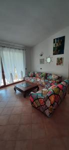a living room with a couch and a table at Artistika Golden Apartment in Capitana
