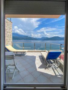 a patio with a view of the water from a window at Leut Apartments in Tivat