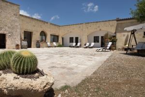 a patio with a cactus in front of a building at Antica Masseria Ficazzana - Tenuta in Marina di Pescoluse +37 photos