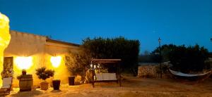 a building with a sign in front of it at Antica Masseria Ficazzana - Tenuta in Marina di Pescoluse