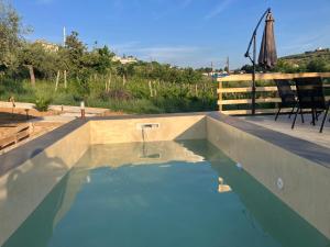 a swimming pool with blue water on a patio at Pantani in Collecorvino