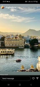 a view of a river with buildings and a city at Devi Villa in Udaipur