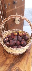 a basket of chestnuts sitting on a wooden table at Antica Masseria Ficazzana - Tenuta in Marina di Pescoluse