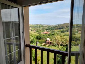a view from a balcony with a view of the countryside at Apartamentos Corona in Comillas