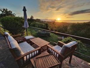 a patio with a table and chairs and an umbrella at Apartamentos Corona in Comillas
