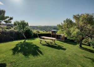 a picnic table in the middle of a grass field at Apartamentos Corona in Comillas