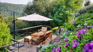 a patio with two chairs and an umbrella at Apartamentos Corona in Comillas