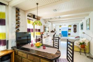 a kitchen with a table and a dining room at Beach House Sveti Jakov 2 in Dubrovnik