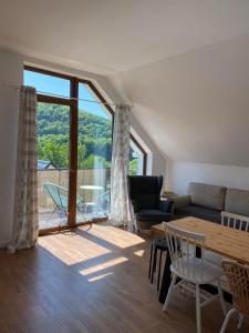 a living room with a couch and a table at Solina Bieszczady Noclegi in Solina