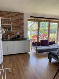 a living room with a couch and a brick wall at Solina Bieszczady Noclegi in Solina