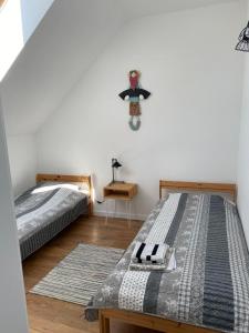 a bedroom with two beds and a teddy bear on the wall at Solina Bieszczady Noclegi in Solina