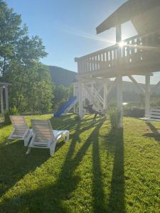 two chairs under a gazebo in a yard at Solina Bieszczady Noclegi in Solina