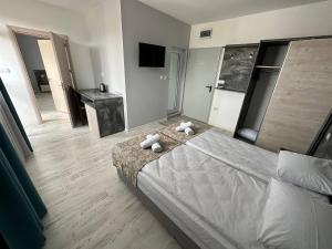 a bedroom with a bed with two teddy bears on it at Studios and Apartments Pomorie in Pomorie