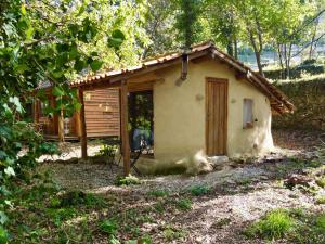 a small house in the middle of a forest at Eco-Hostel Quinta das Relvas in Branca