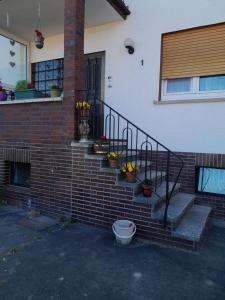 a brick stairway with potted plants on the side of a house at ZiniMiri in Freiensteinau