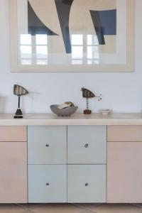 a white counter with two lamps on top of it at Nefeli's House in Souvala