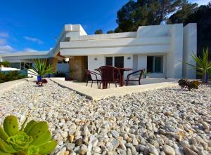 a house on the beach with a large pile of rocks at Ibiza 7th Heaven Villa in Sant Josep