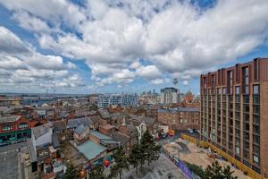 a view of a city with buildings and clouds at Lovely Central 1-Bedroom Flat with a View, Ideal Getaway in Liverpool