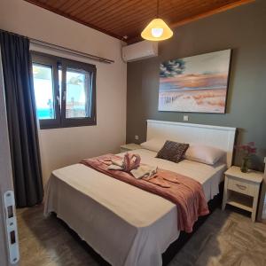 a bedroom with a bed with a towel on it at Pure Blue House in Athanion