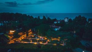 a view of a town at night with lights at SIMI Luxury Suites in Plaka Litochorou