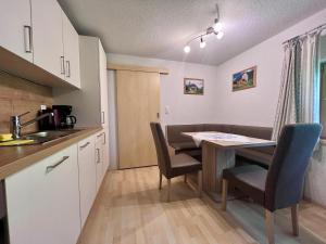 a kitchen with a table and chairs in a room at Kiblerhof in Russbach am Pass Gschütt