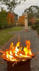 a fire pit in a park with flames at The Church at Barrington in Barrington