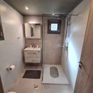 a bathroom with a shower and a sink at Pure Blue House in Athanion