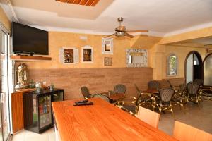 a dining room with a large wooden table and chairs at Hotel Vista Sol in Cala Ratjada